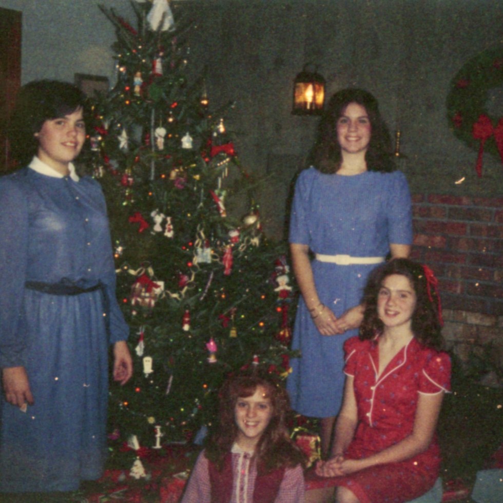 Early 1980s photo of me and my sisters at Christmas.